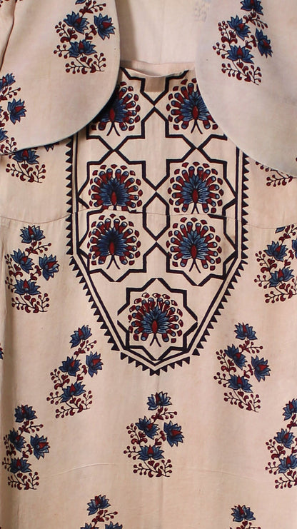 Floral-patterned fabric draped over a branch with greenery in the background